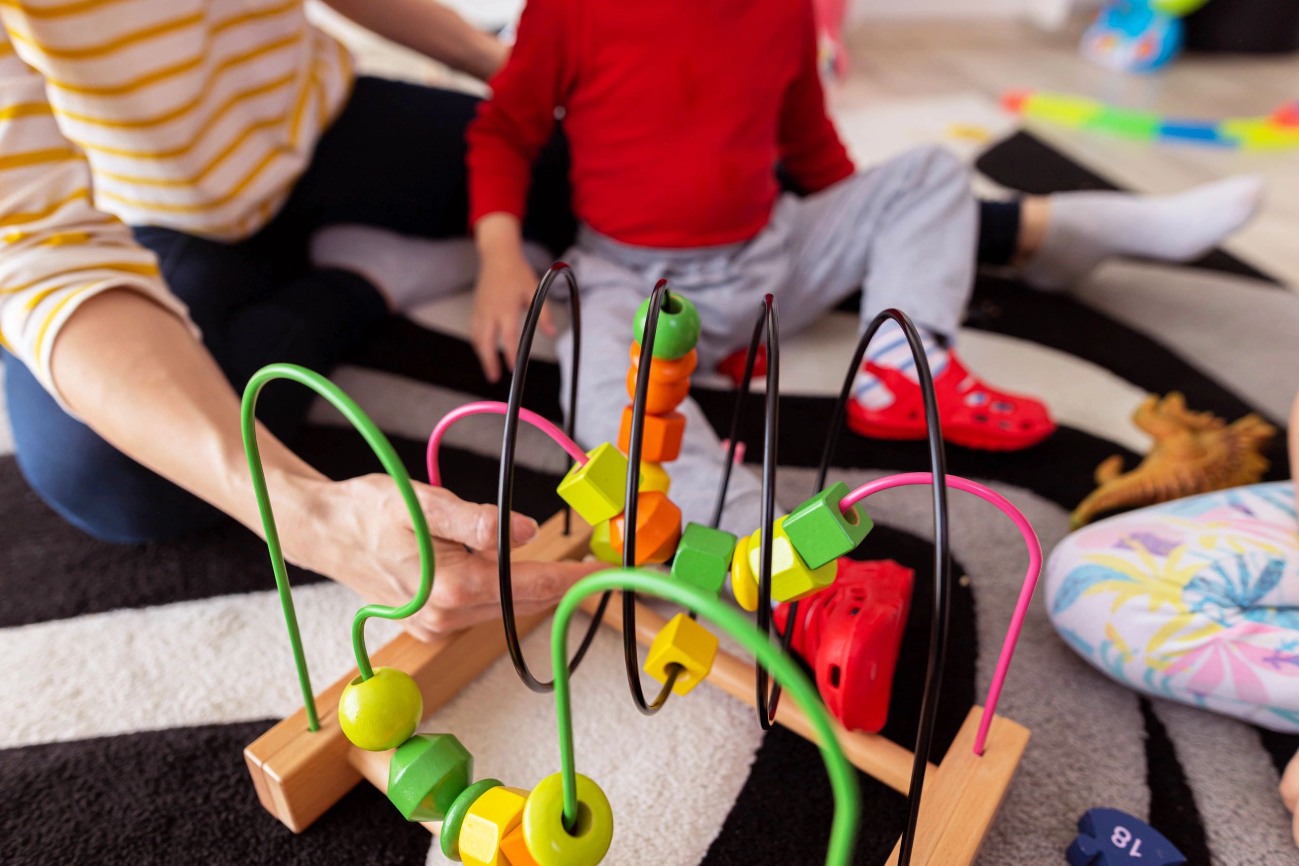 Parent and children playing together on the floor at home